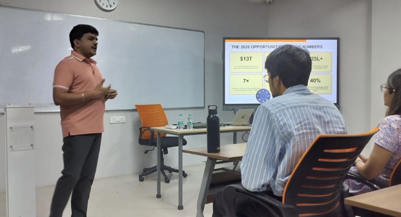 Sheshakanth Munagapati teaching an AI product management session at Rockwell Business School, with a slide titled 'The 2026 Opportunity' on screen